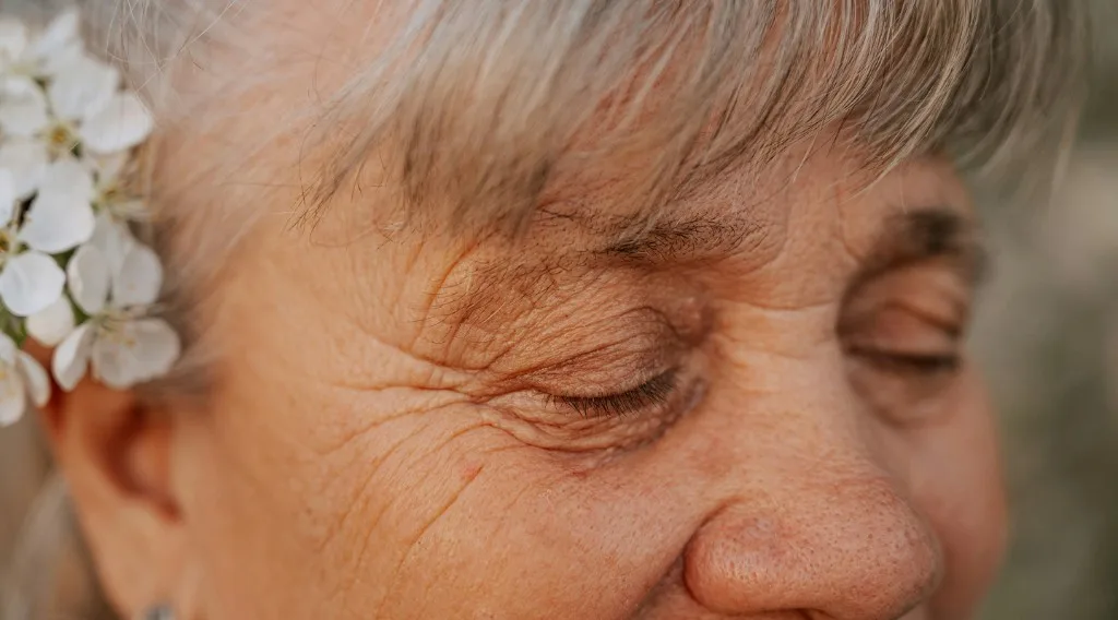 Close-up portrait of an older woman with her eyes closed