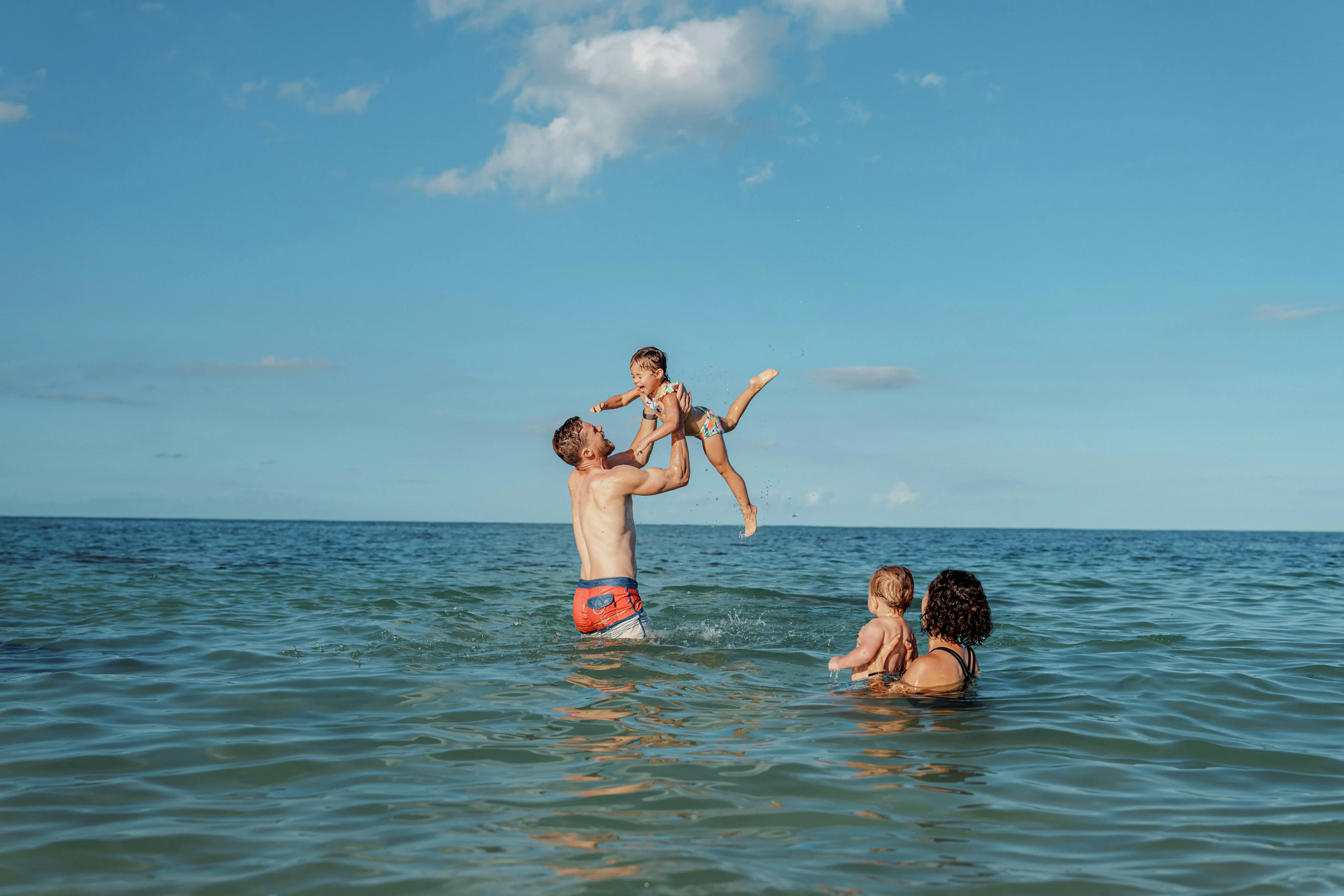 Family playing together in the ocean water